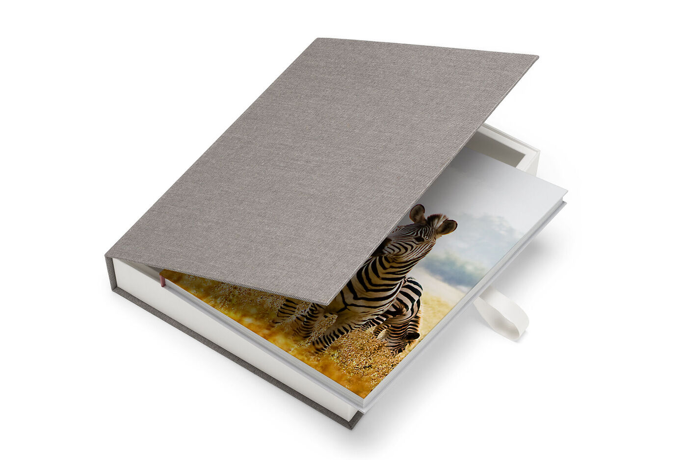 En öppen CEWE FOTOBOK med en zebra på första sidan i en hjärtlig miljö.