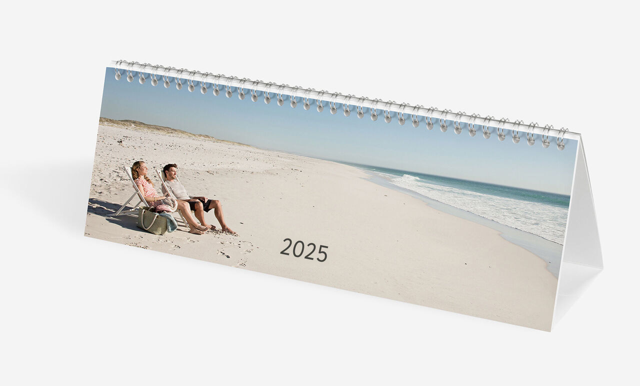 CEWE fotokalender med ett par på stranden som njuter av solnedgången år 2025