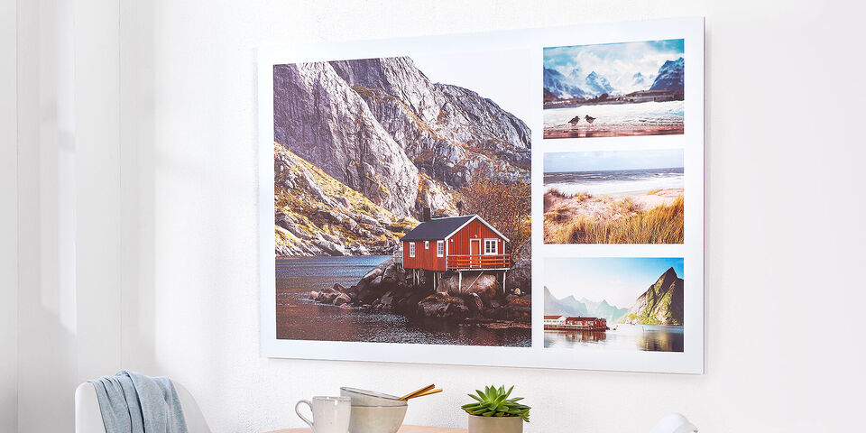 En väggkonst med fantastiska landskapsbilder i en modern ram. Den visar ett rött hus vid vattnet.
