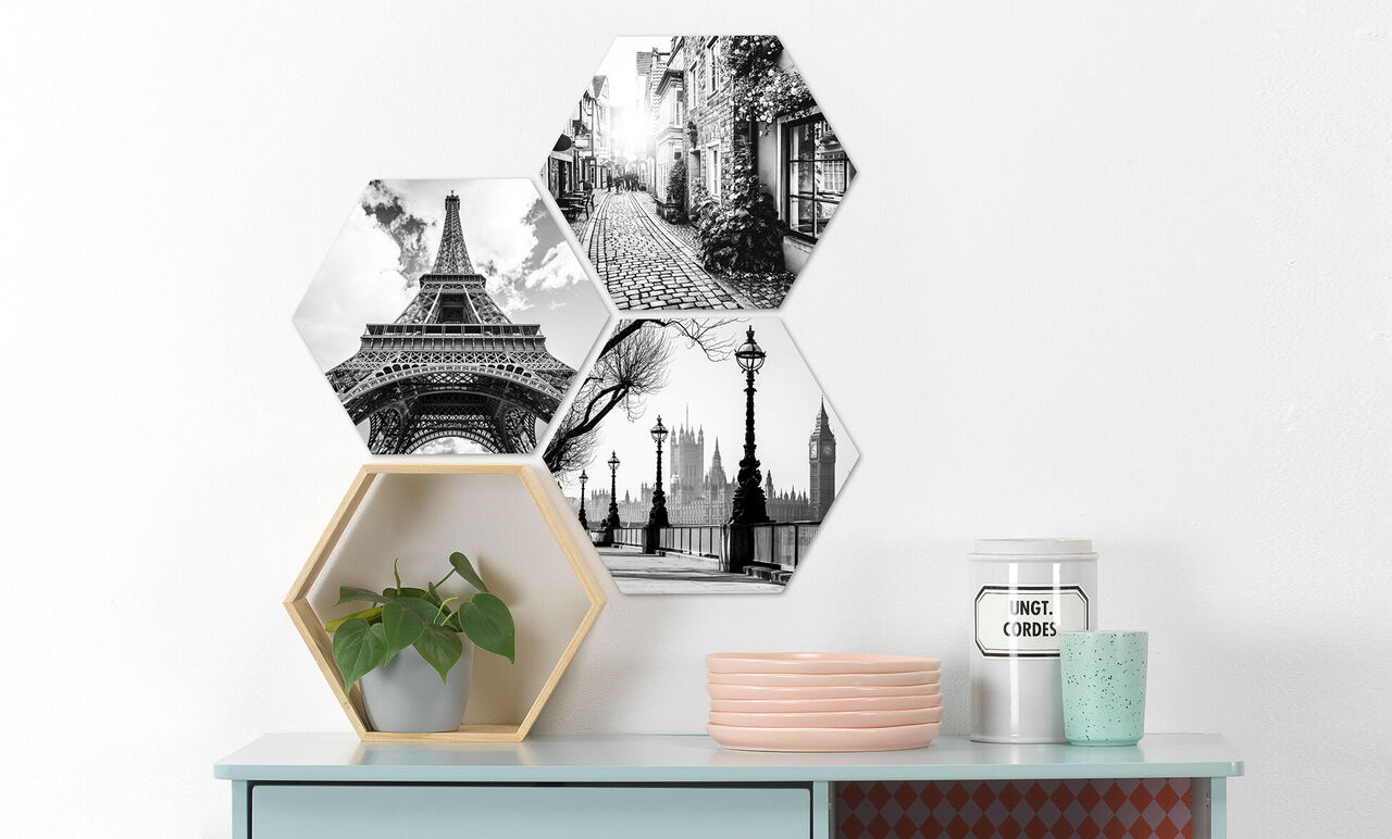 Tre hexagonala bilder i svart-vitt med sevärdheter som Eiffeltornet, Londons skyline och en stadsgata.