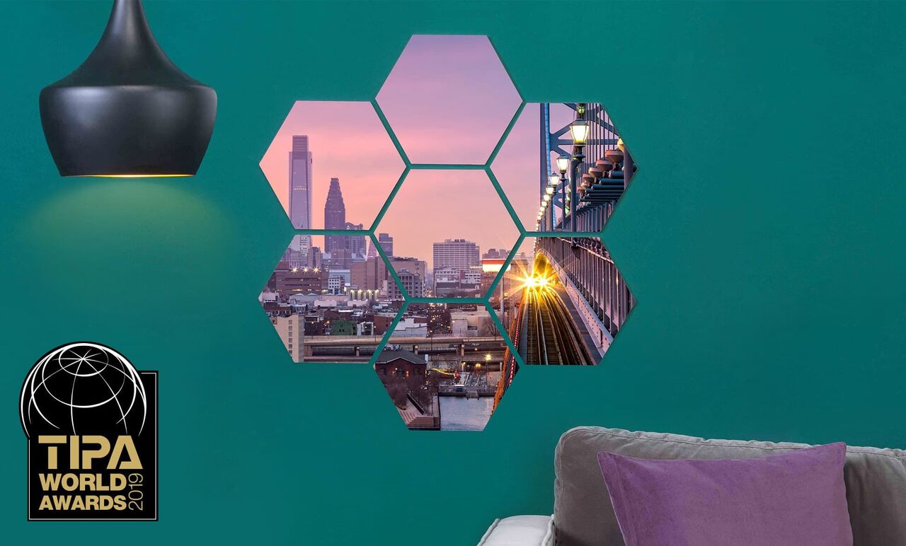 Sexkantig väggdesign med stadsutsikt och solnedgång.