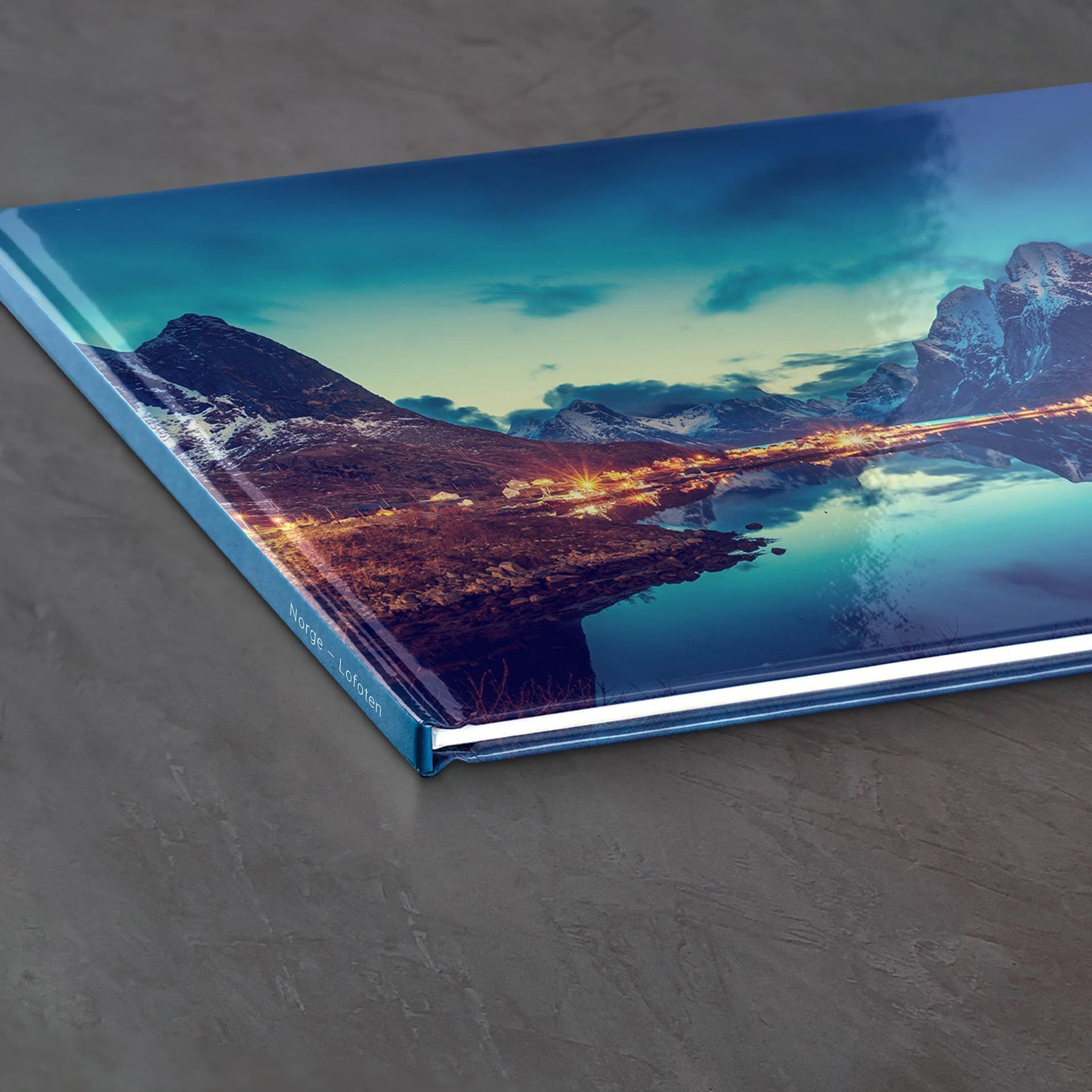 CEWE FOTOBOK med vacker landskapsdesign på ett träbord